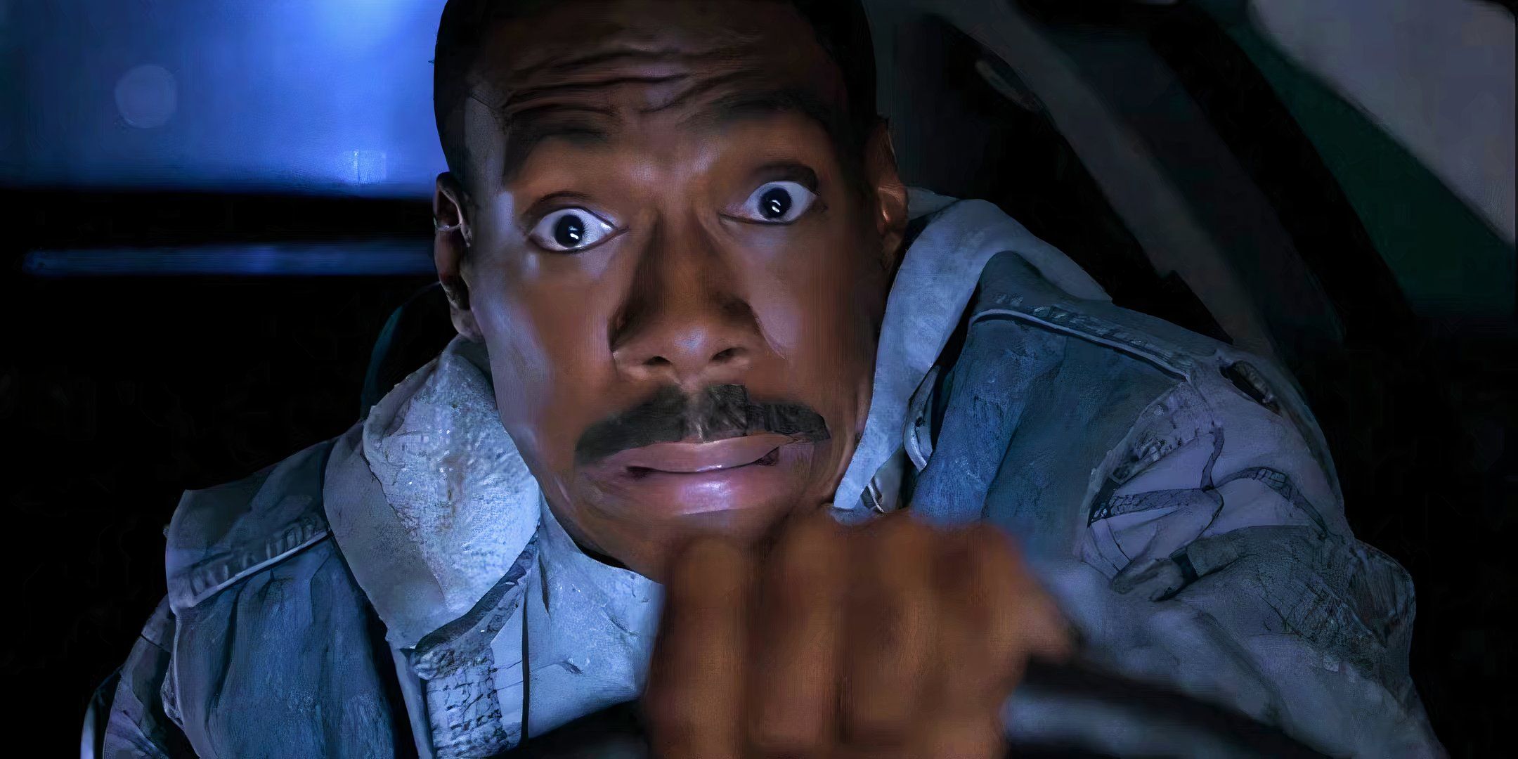 Axel Foley pulls a terrified face while driving in Beverly Hills Cop 3