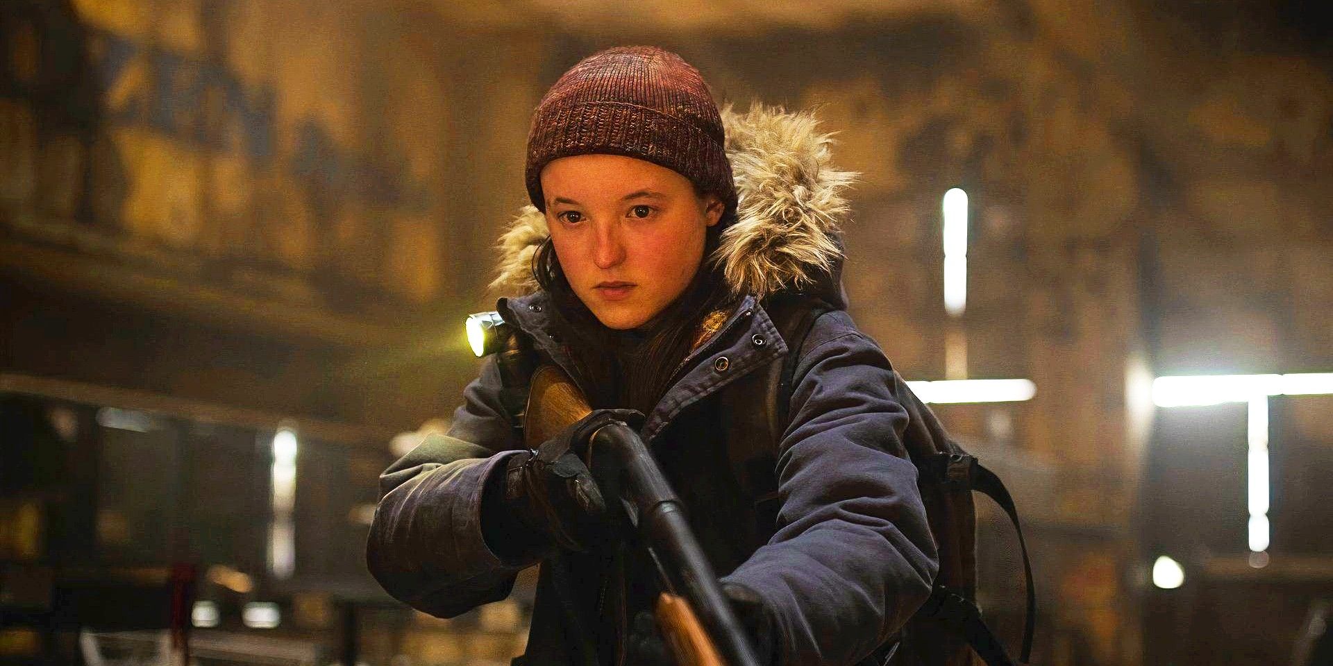 Bella Ramsey as Ellie wearing winter clothes and holding a shotgun in The Last of Us season 2