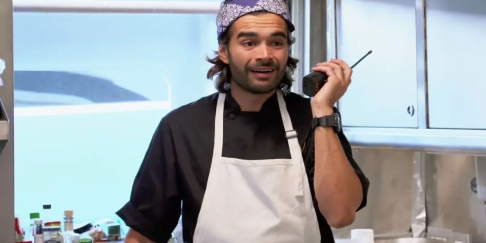 Chef Kiko during Below Deck Med on the phone in the galley 