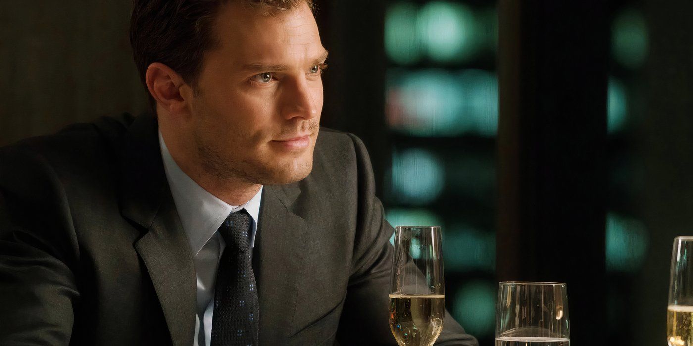 Christian sits with champagne in Fifty Shades