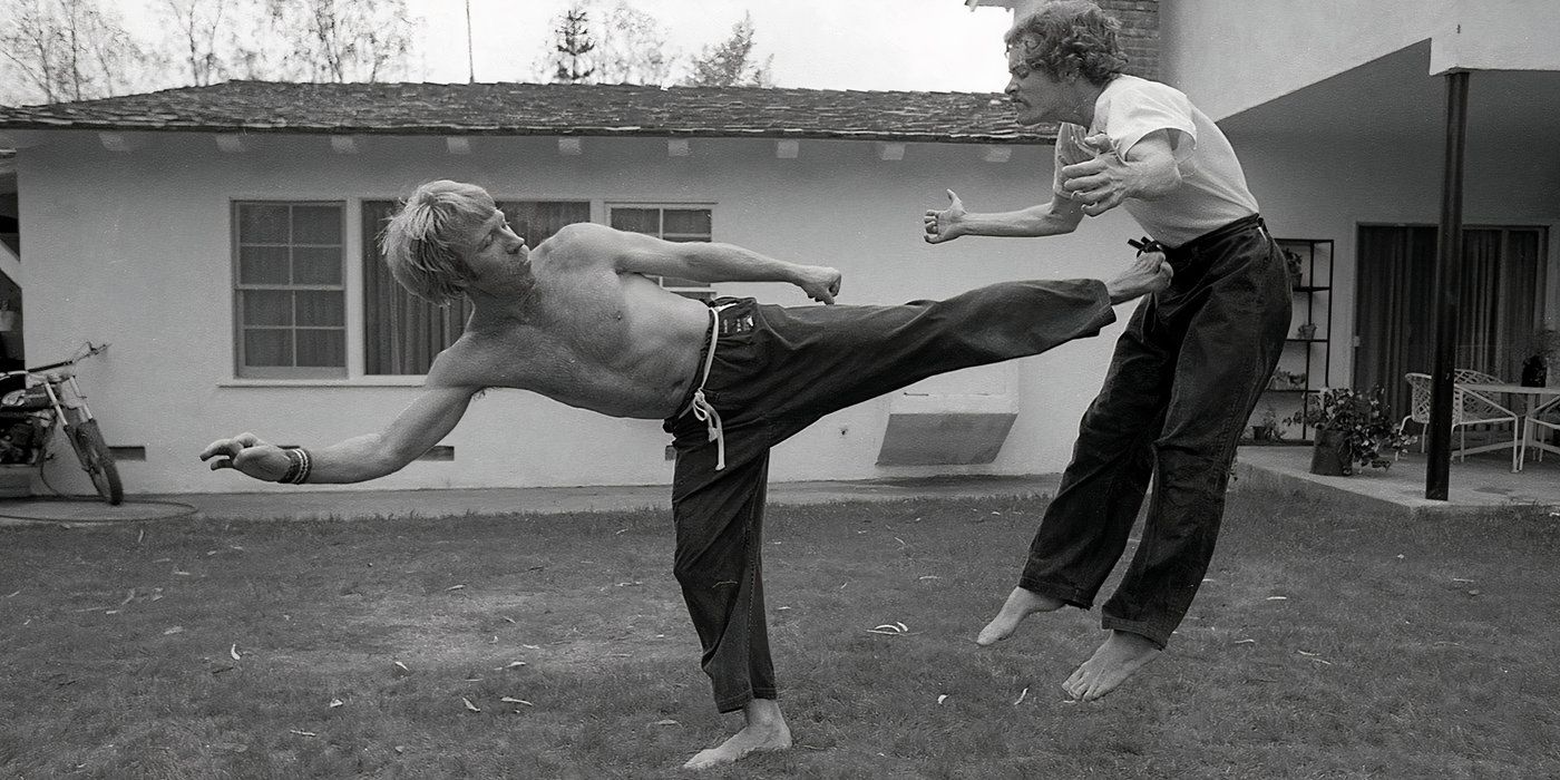 Chuck Norris using Karate and kicking his opponent
