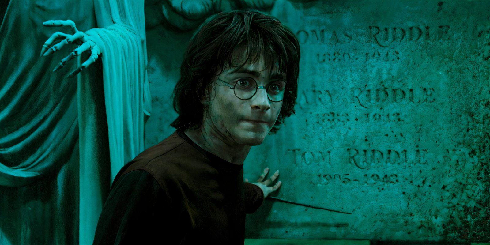 Daniel Radcliffe as Harry touching a gravestone in Harry Potter and the Goblet of Fire