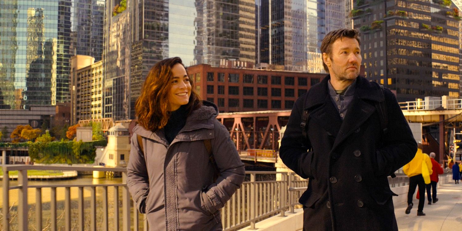 Amanda (Alice Braga) e Jason Dessen (Joel Edgerton) caminhando por uma paisagem urbana futurista e pacífica no episódio 7 da 1ª temporada de Dark Matter