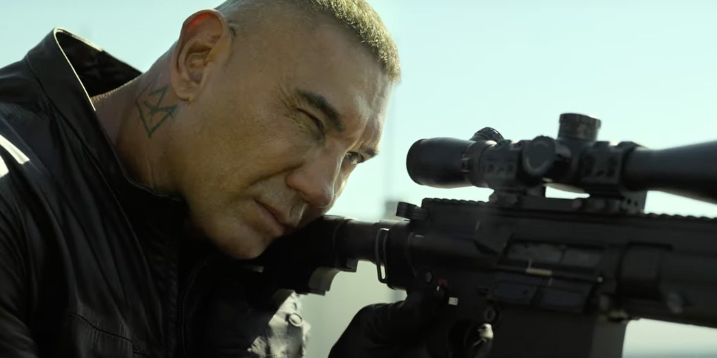 Dave Bautista Aims a Rifle In The Killer's Game