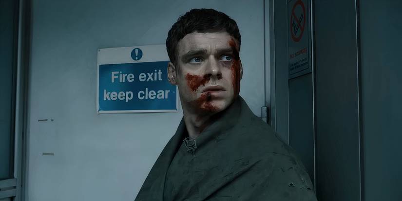David hiding around a corner in Bodyguard