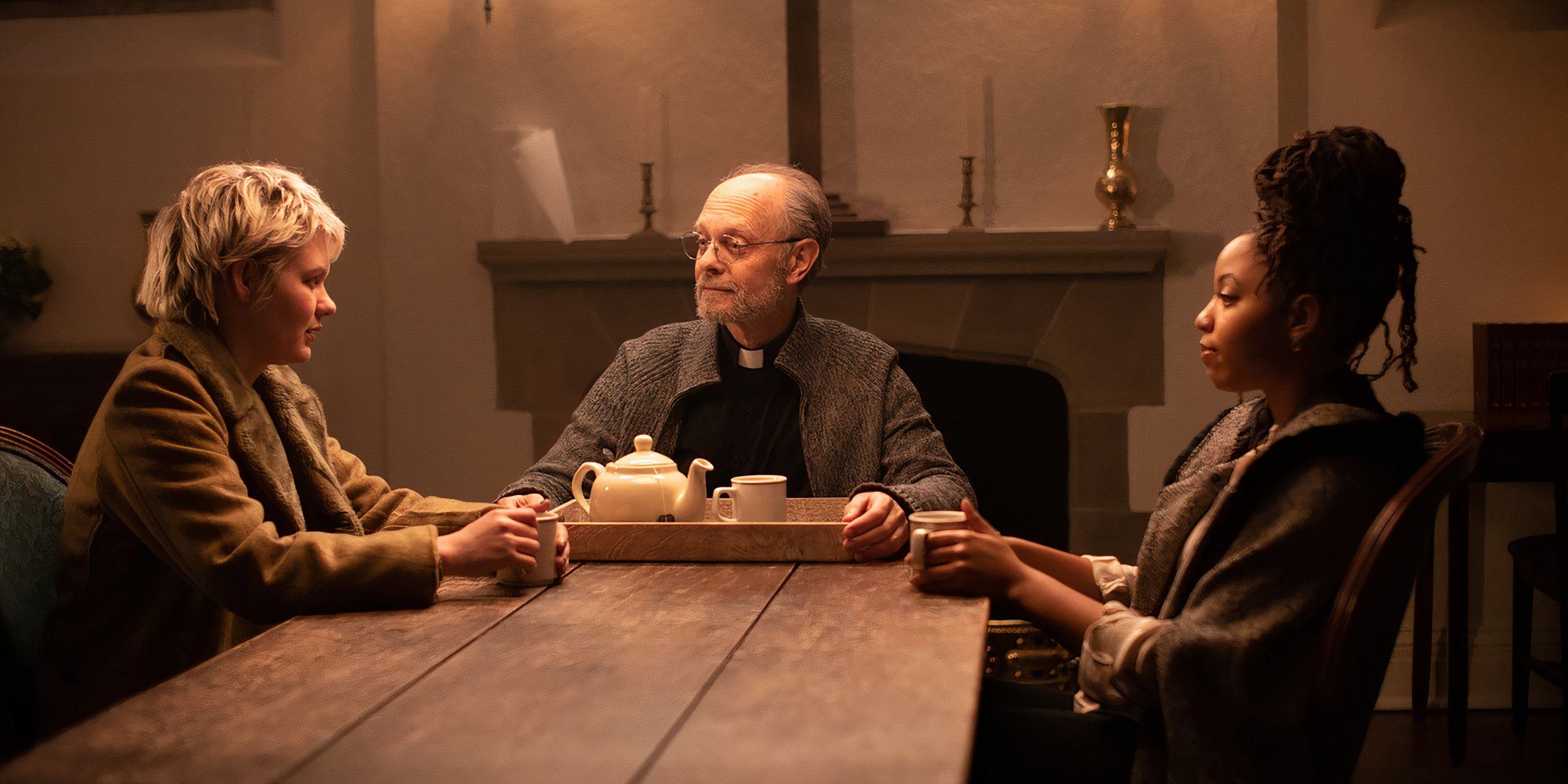 David Hyde Pierce as Father Conor having a conversation with Ryan Simpkins' Lee and Chloe Bailey's Blake in The Exorcism