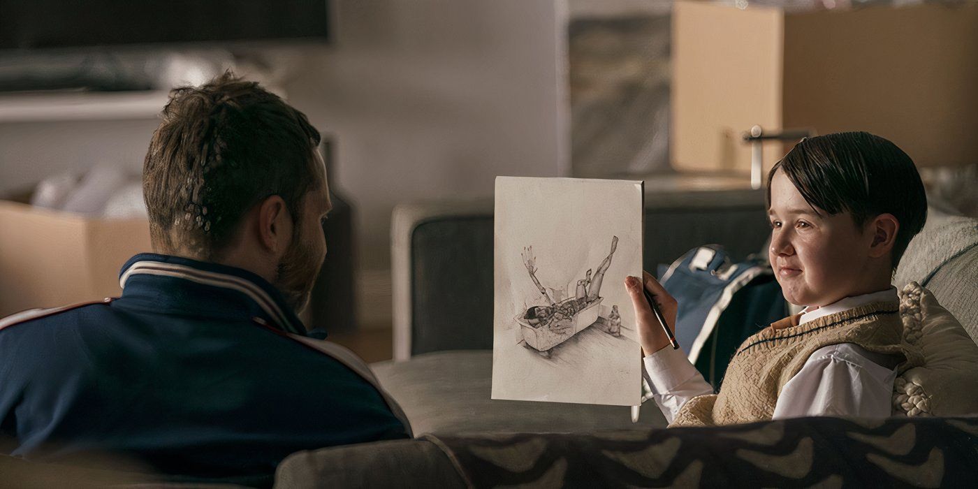 Aaron shows Liam a drawing while they sit on the couch in Everyone Else Burns