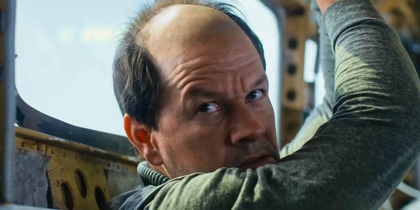 Mark Wahlberg with his hands above his head in Flight Risk