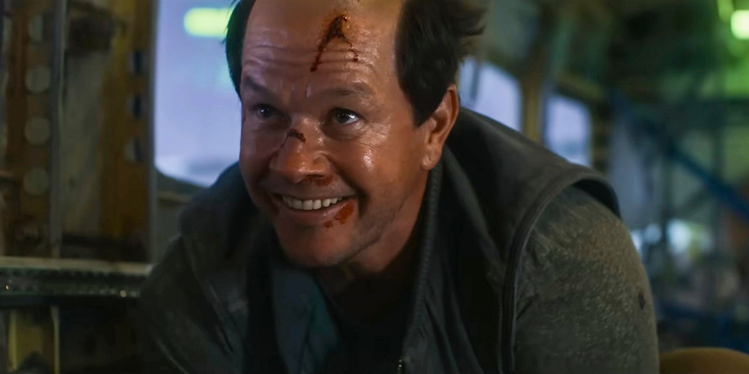 Mark Wahlberg smiling with cuts on his face in Flight Risk