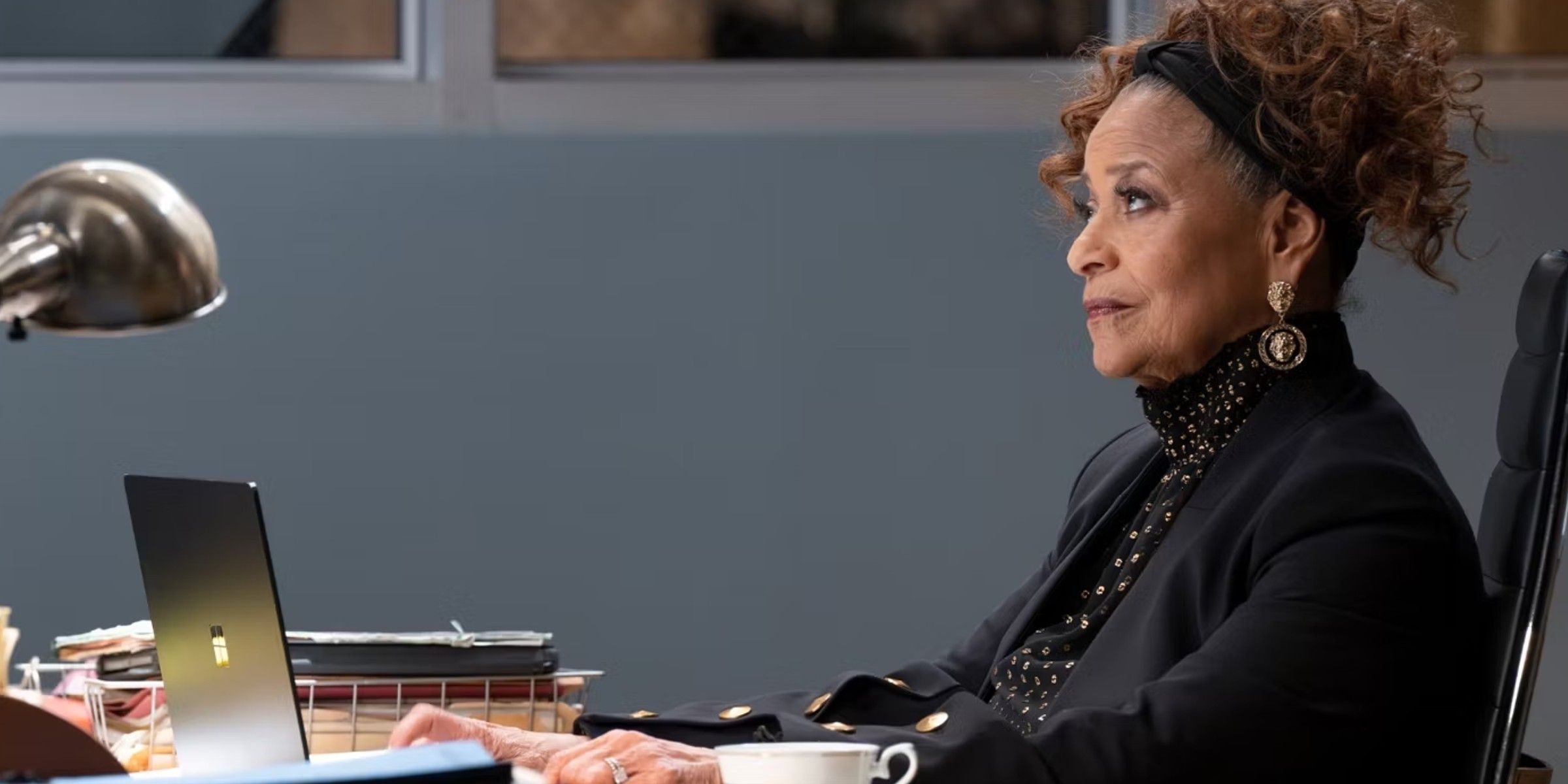 Catherine Fox sits at her desk in Grey's Anatomy Season 20