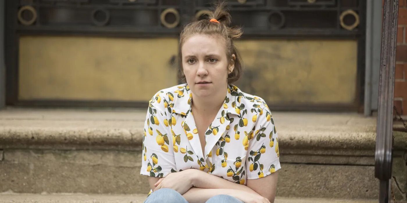 hannah sitting on a stoop in girls