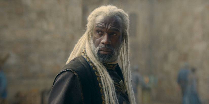 Corlys Velaryon (Steve Toussaint) looks over his shoulder in fear in House of the Dragon season 2 episode 1