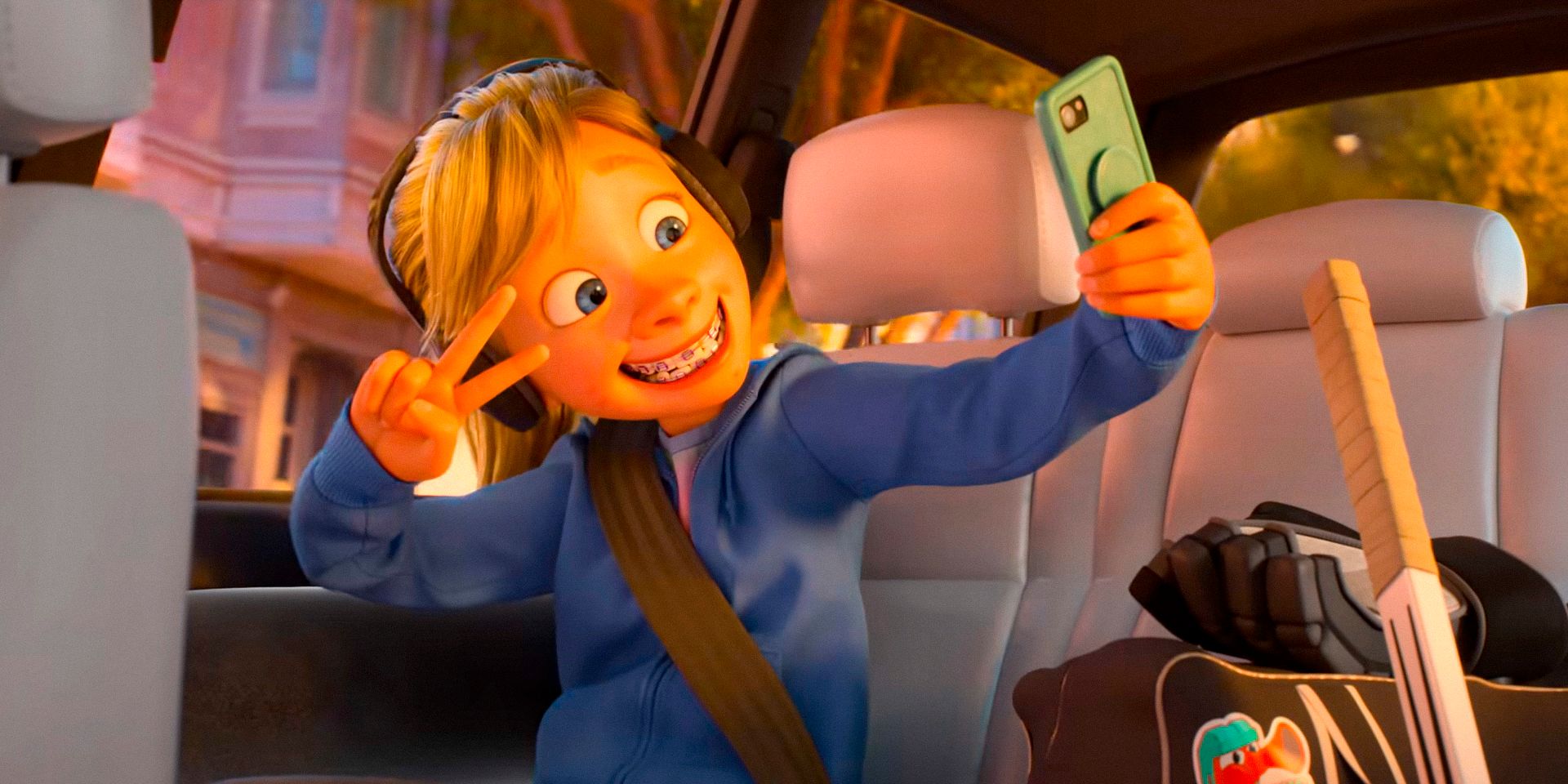 Riley takes a selfie while riding in an Uber in Inside Out 2