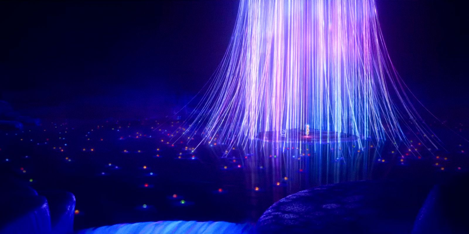 A waterfall formed by luminous threads that seem to lead to different memories in Riley's memory in Inside Out 2