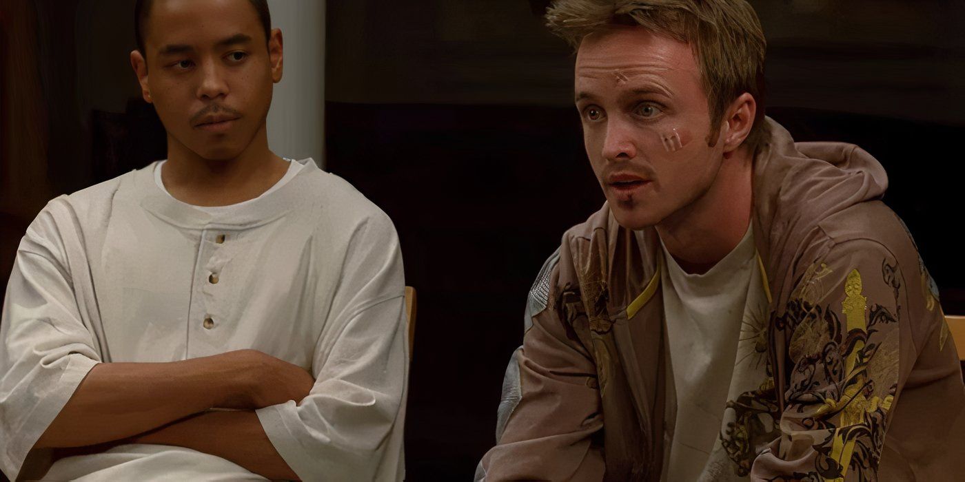 Jesse Pinkman (Aaron Paul) wearing a tan hoodie and leaning forward and talking with cuts on his face in Breaking Bad.