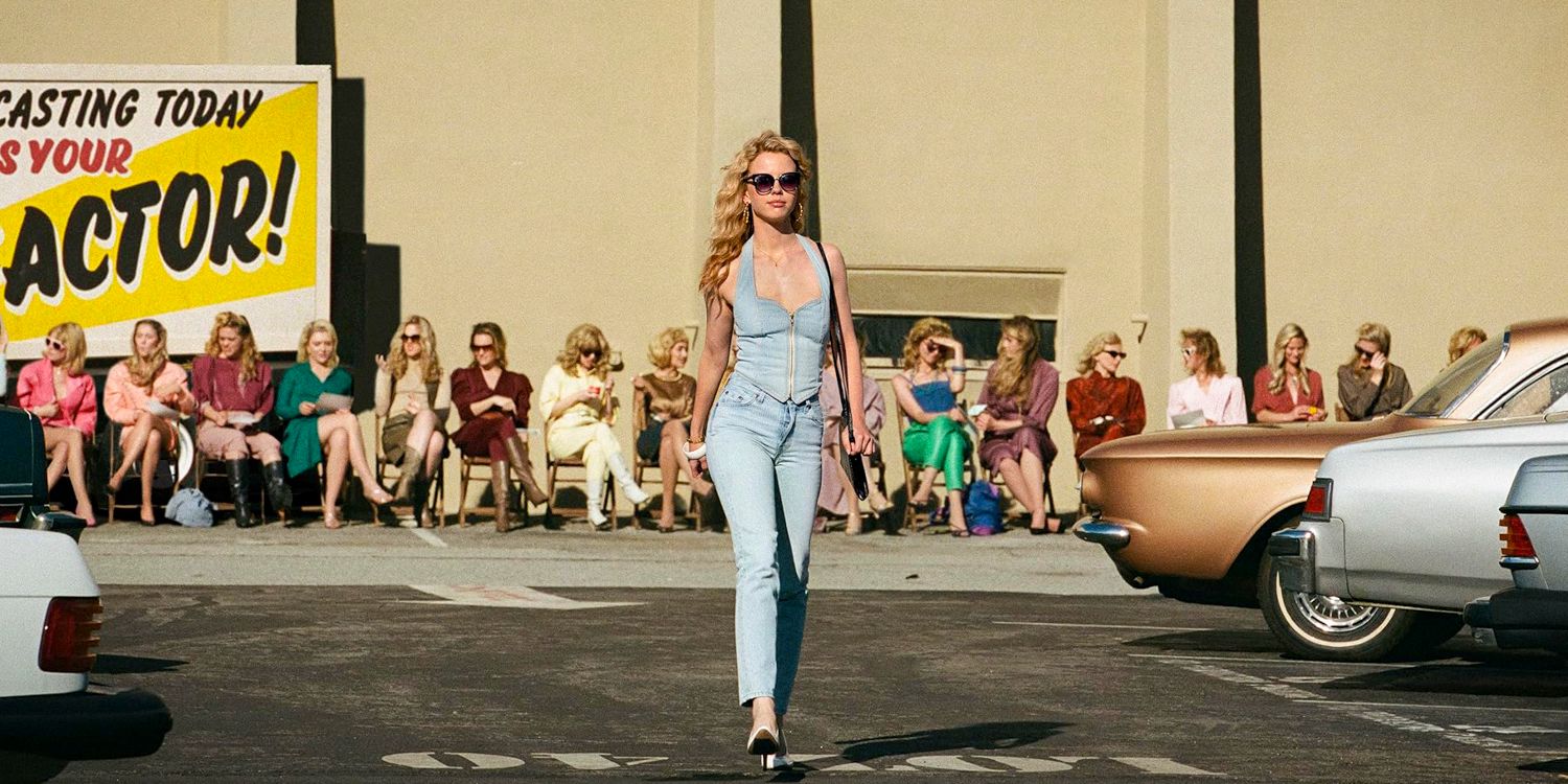 Maxine (Mia Goth) walking stylishly through a parking lot with several women watching her in the background in MaXXXine (2024) 