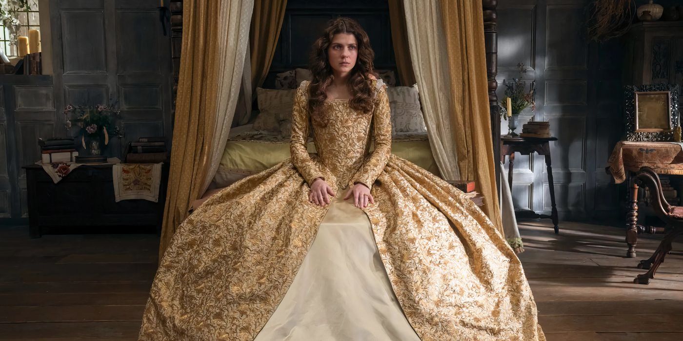 Jane duduk dengan sedih dalam gaun emas dan putih besar di My Lady Jane