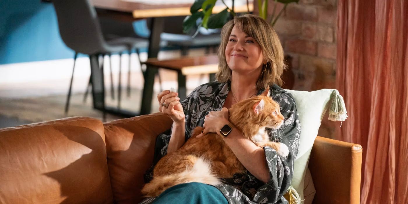 Lucy Lawless as Alexa Crowe holding a dog in My Life is Murder.