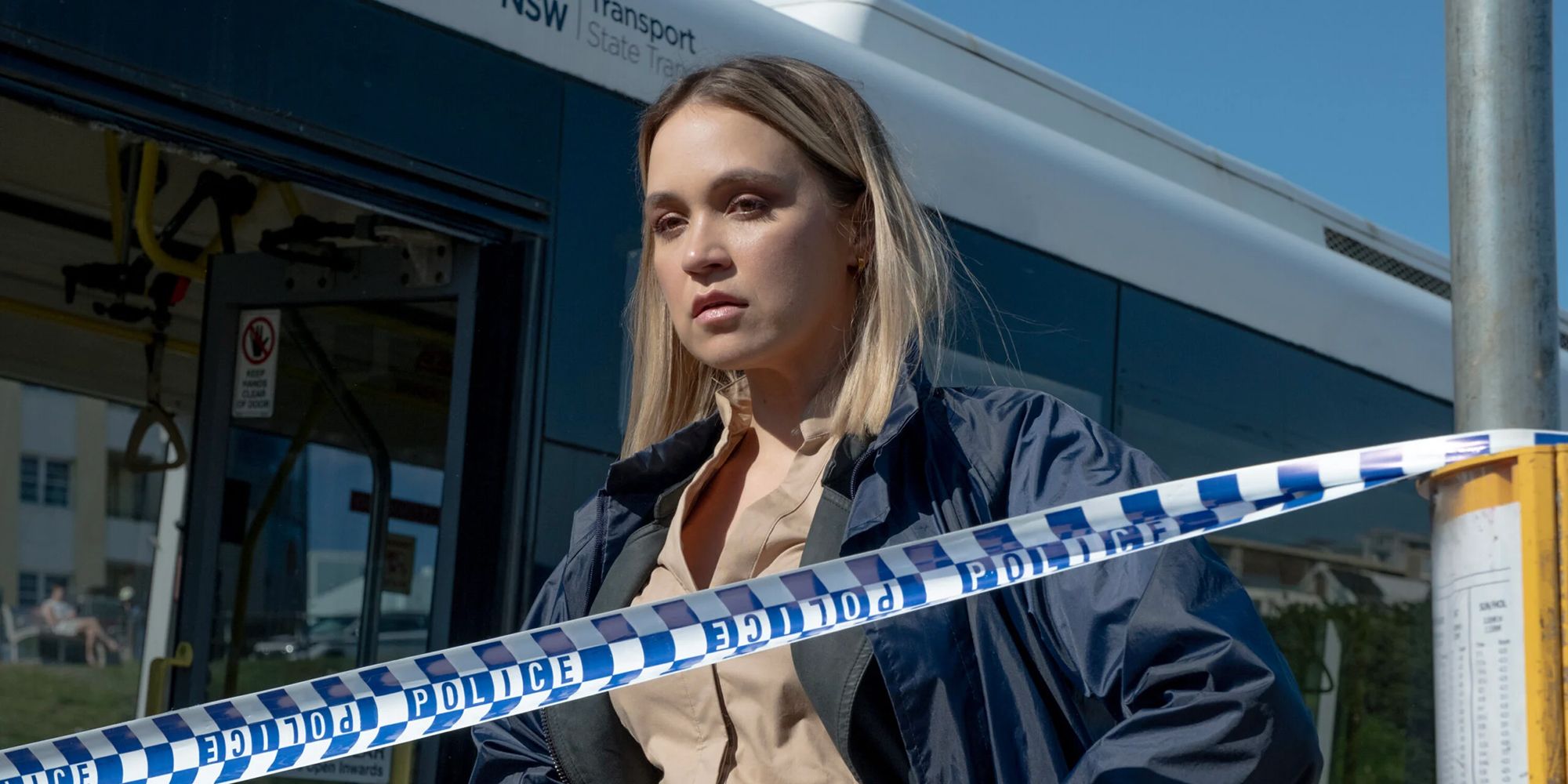 NCIS Sydney Evie Cooper standing in front of a bus