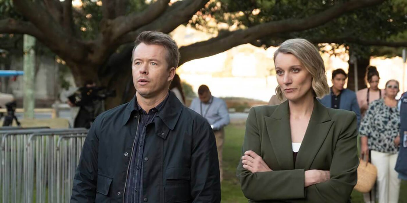 NCIS: Sydney Jim JD Dempsey standing next to an officer in a green blazer