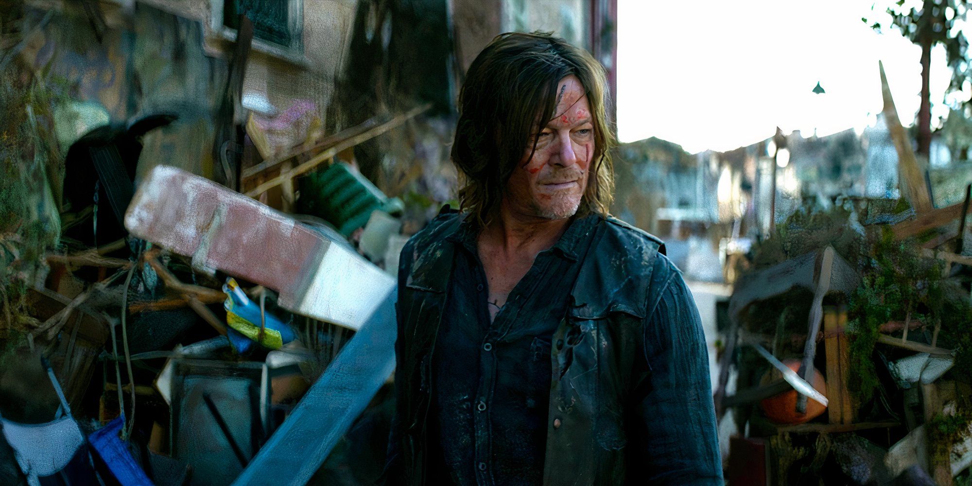 Norman Reedus stands bloody and battered, gazing around as if stunned at the rubble, in a scene from The Walking Dead: Daryl Dixon season 1
