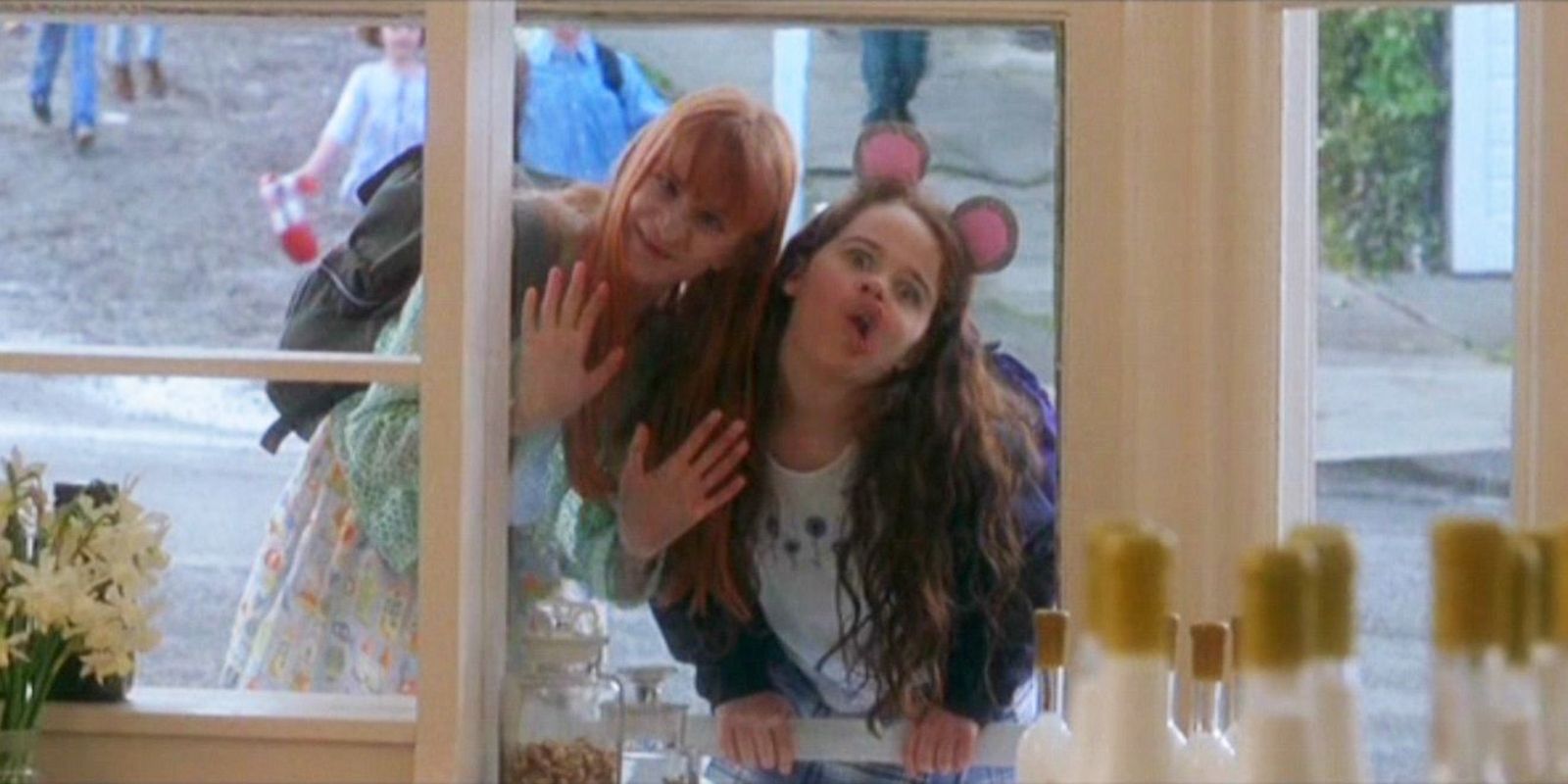 Sally's daughters making goofy faces outside a window in practical magic