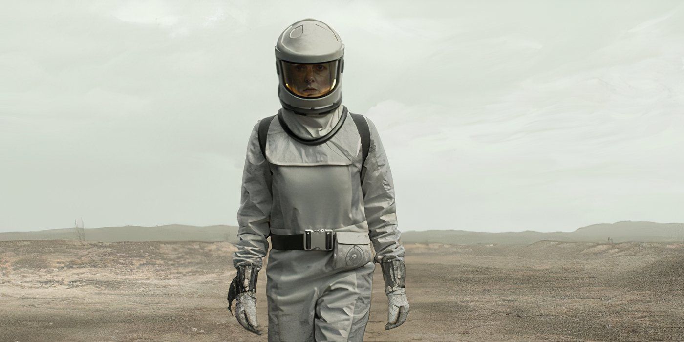 Rebecca Ferguson walking through a dusty field in Silo season 2