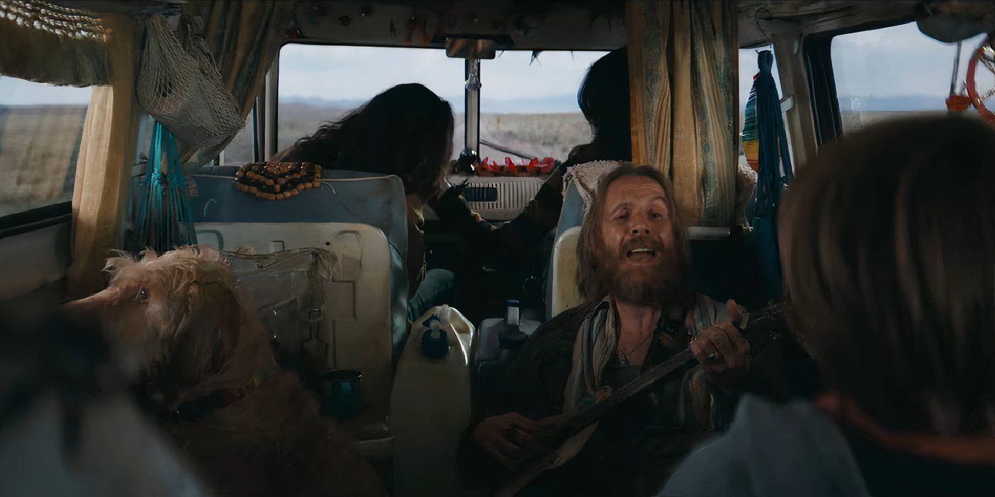 Rhys Ifans playing guitar in a van in Venom The Last Dance