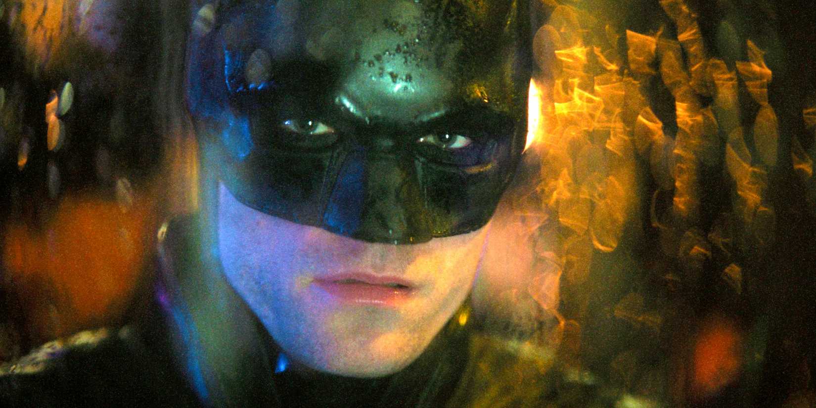 Robert Pattinson as Batman Looking Through A Rainsoaked Window In The Batman