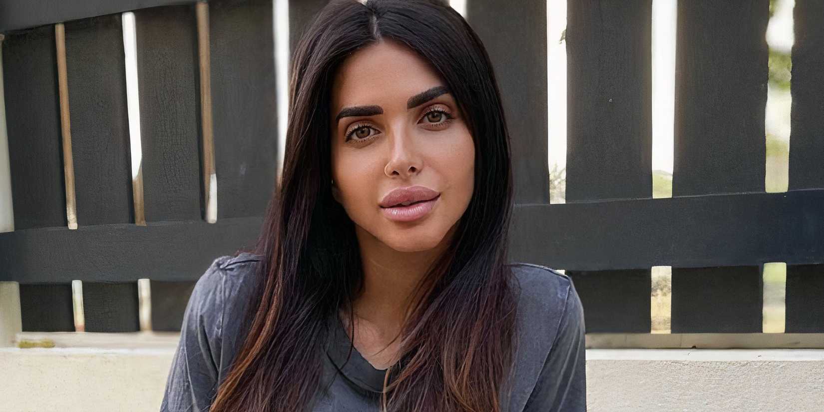 Sara Al Madani posing in grey shirt from RHODubai