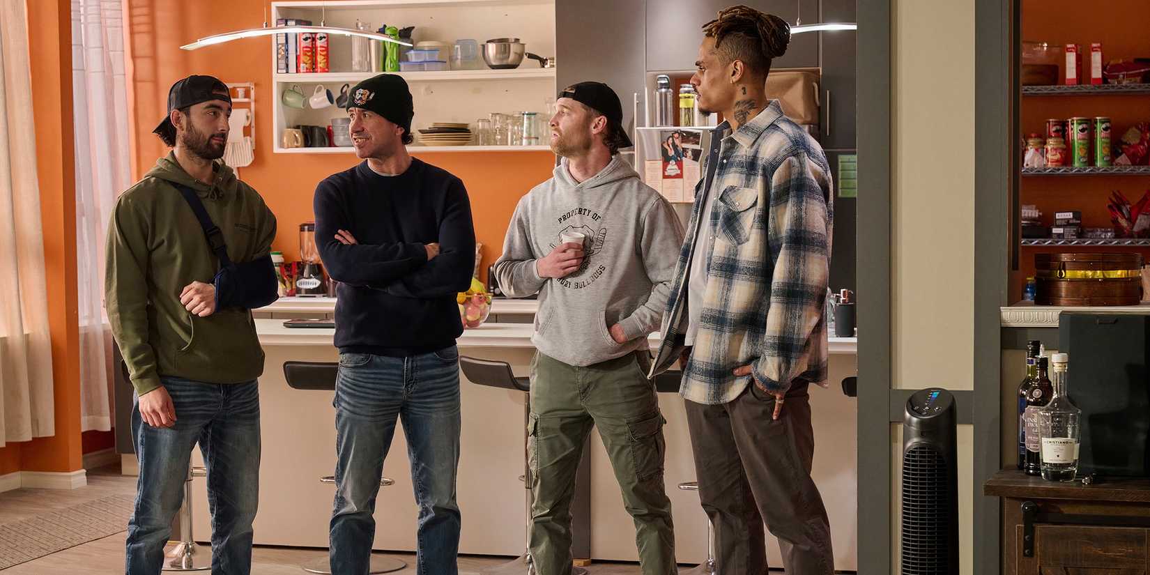 Shoresy and some hockey players talking in their apartment in Shoresy season 3