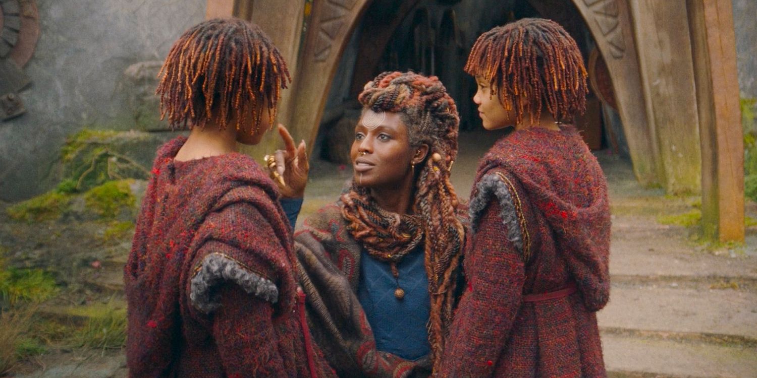 Mother Aniseya (Jodie Turner-Smith) crouching down in front of Little Mae (Leah Brady) and Little Osha (Lauren Brady), talking to them in The Acolyte season 1 episode 3