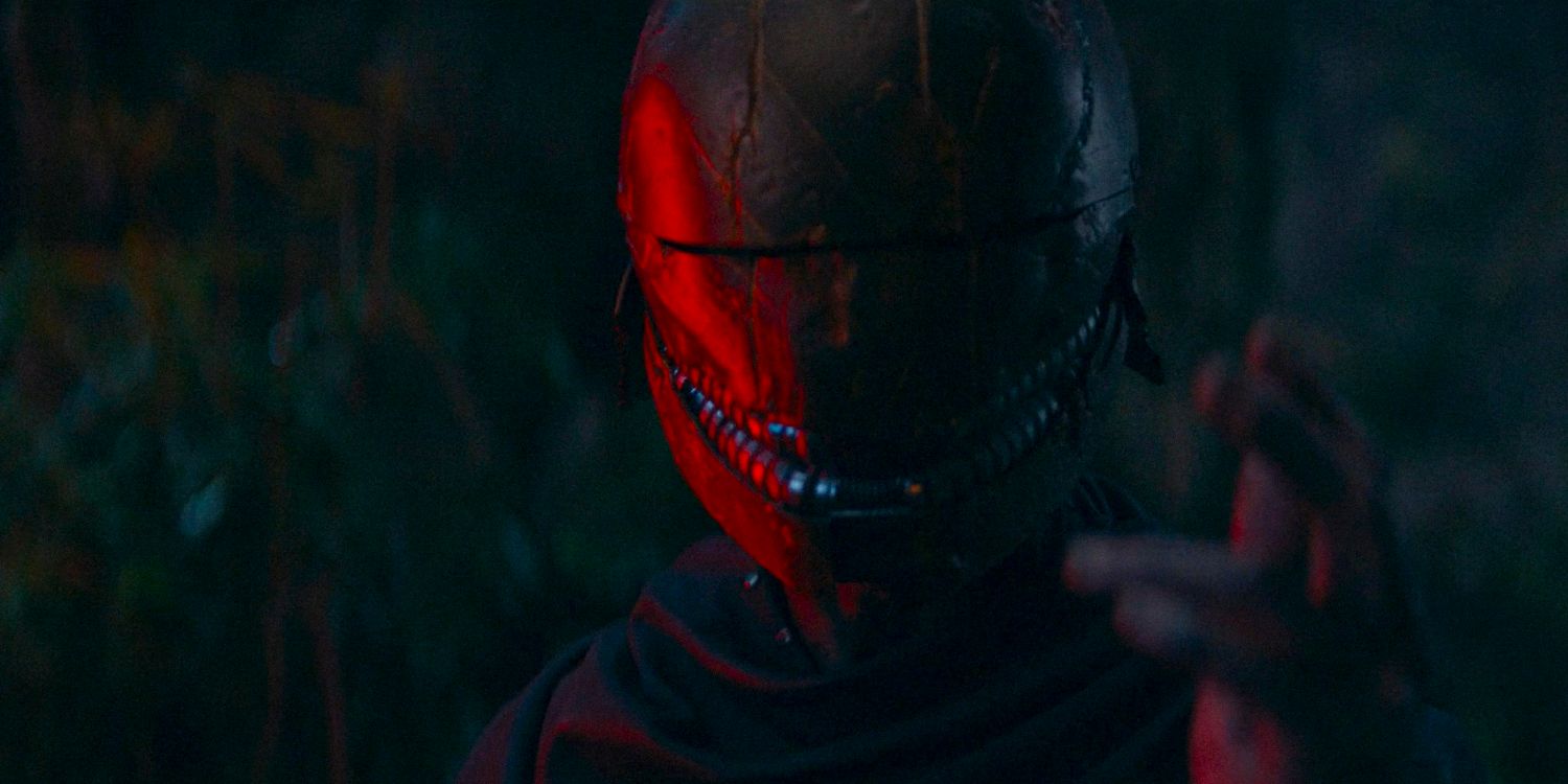 A Sith wearing a helmet and illuminated by the red light of his lightsaber in The Acolyte season 1 episode 4