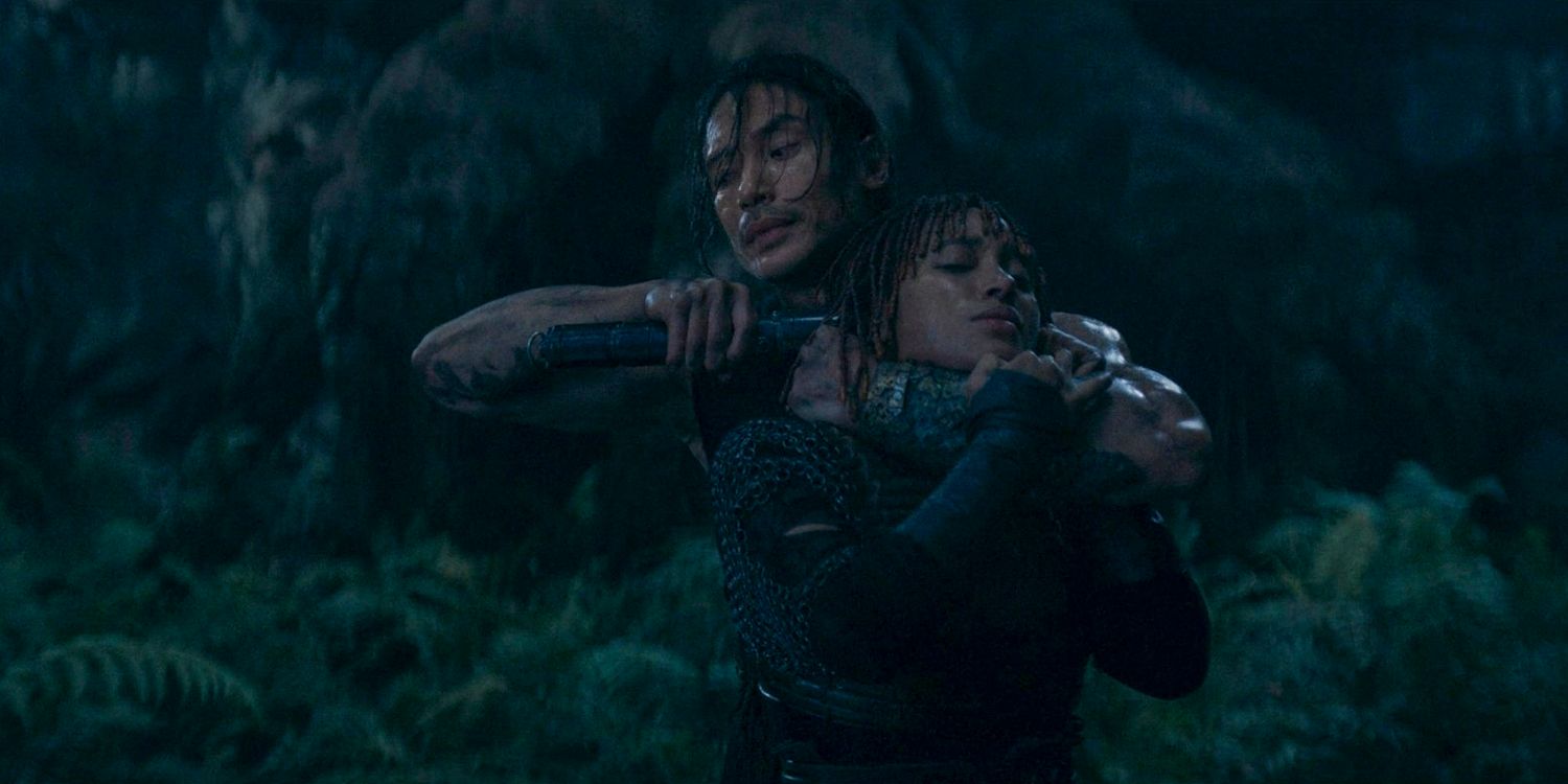 Qimir/Sith (Manny Jacinto) threatening Mae (Amandla Stenberg) with a lightsaber, holding her as a hostage in The Acolyte season 1 episode 5