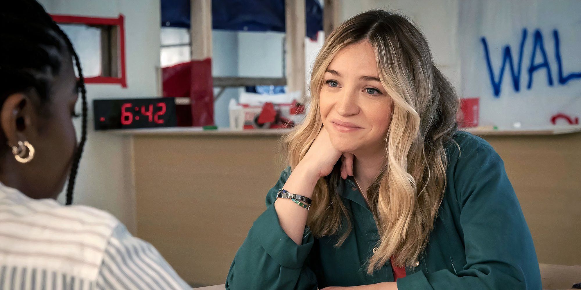 Abby Elliott as Natalie Sugar Berzatto smiling and sitting in The Bear