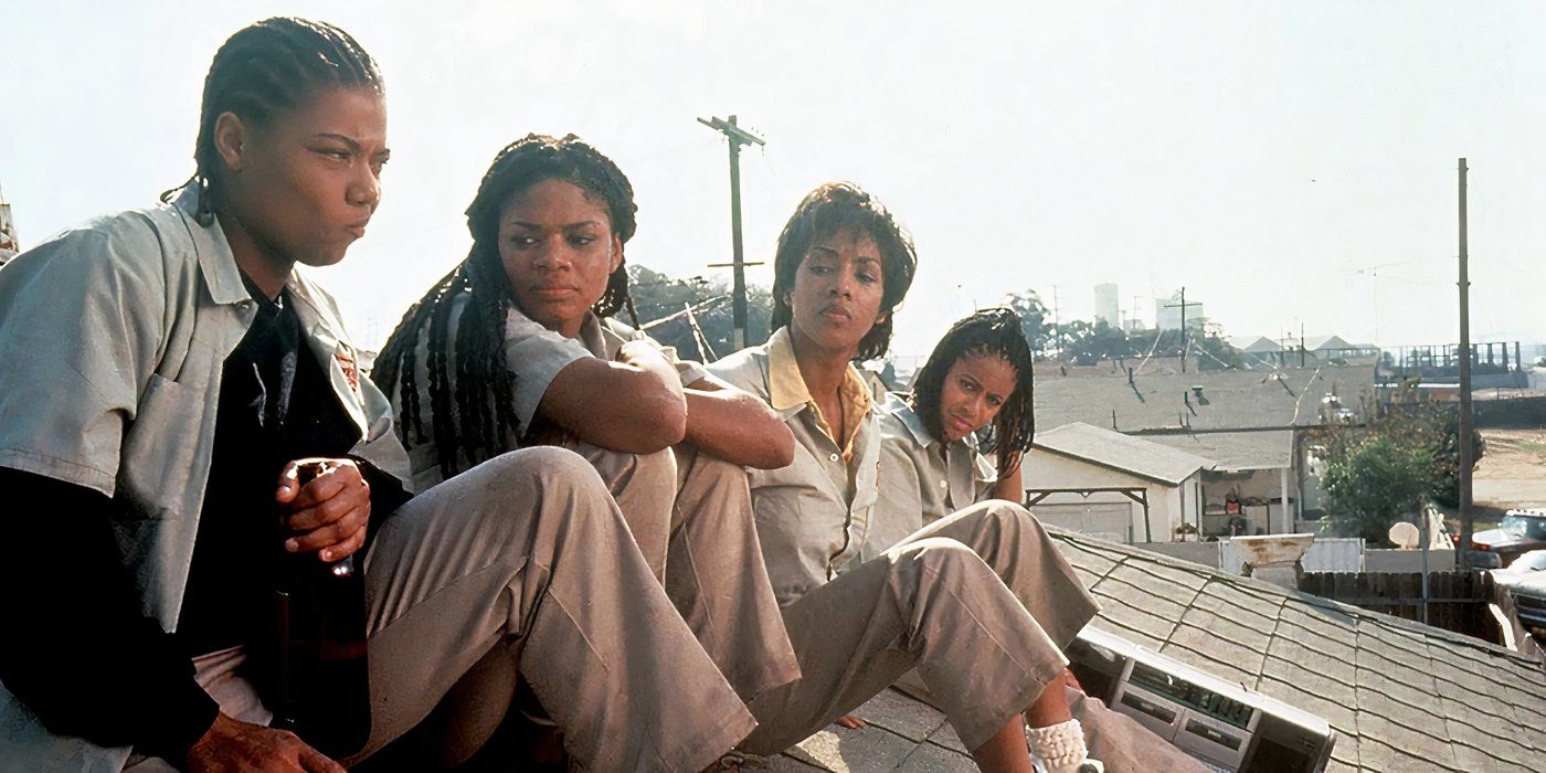 The cast of Set it Off sitting on a roof together.