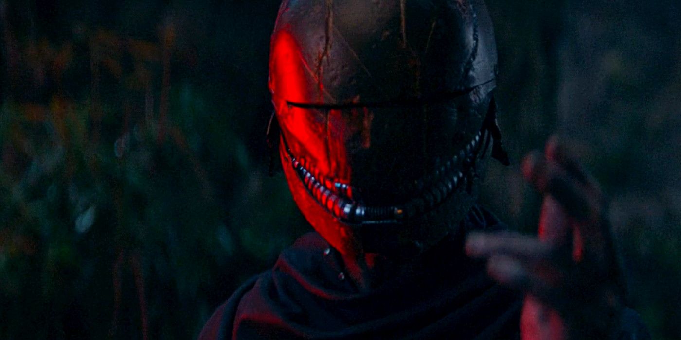 The new Sith Lord looking right at the camera with the red glow from a lightsaber on one side of his mask in in The Acolyte episode 4