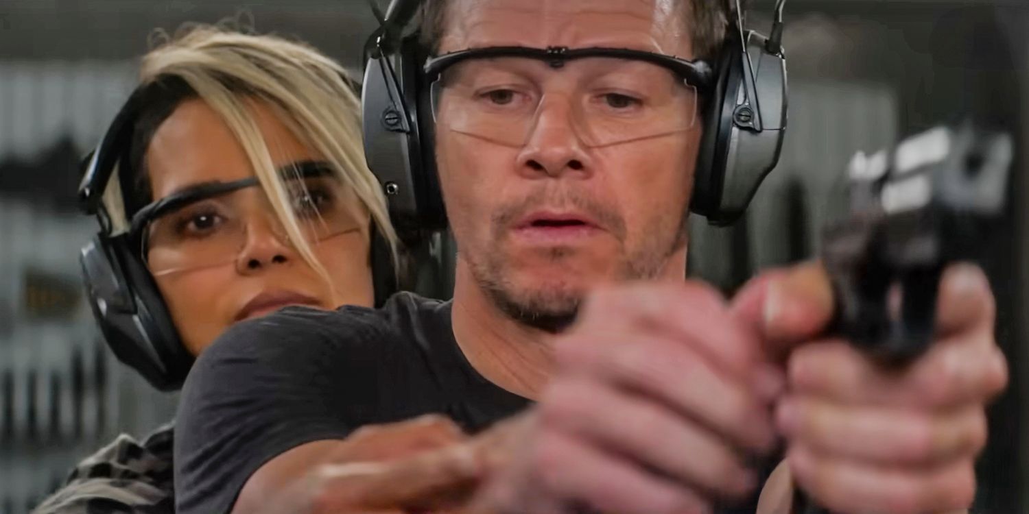 Halle Berry helping Mark Wahlberg learn to aim with a gun in The Union