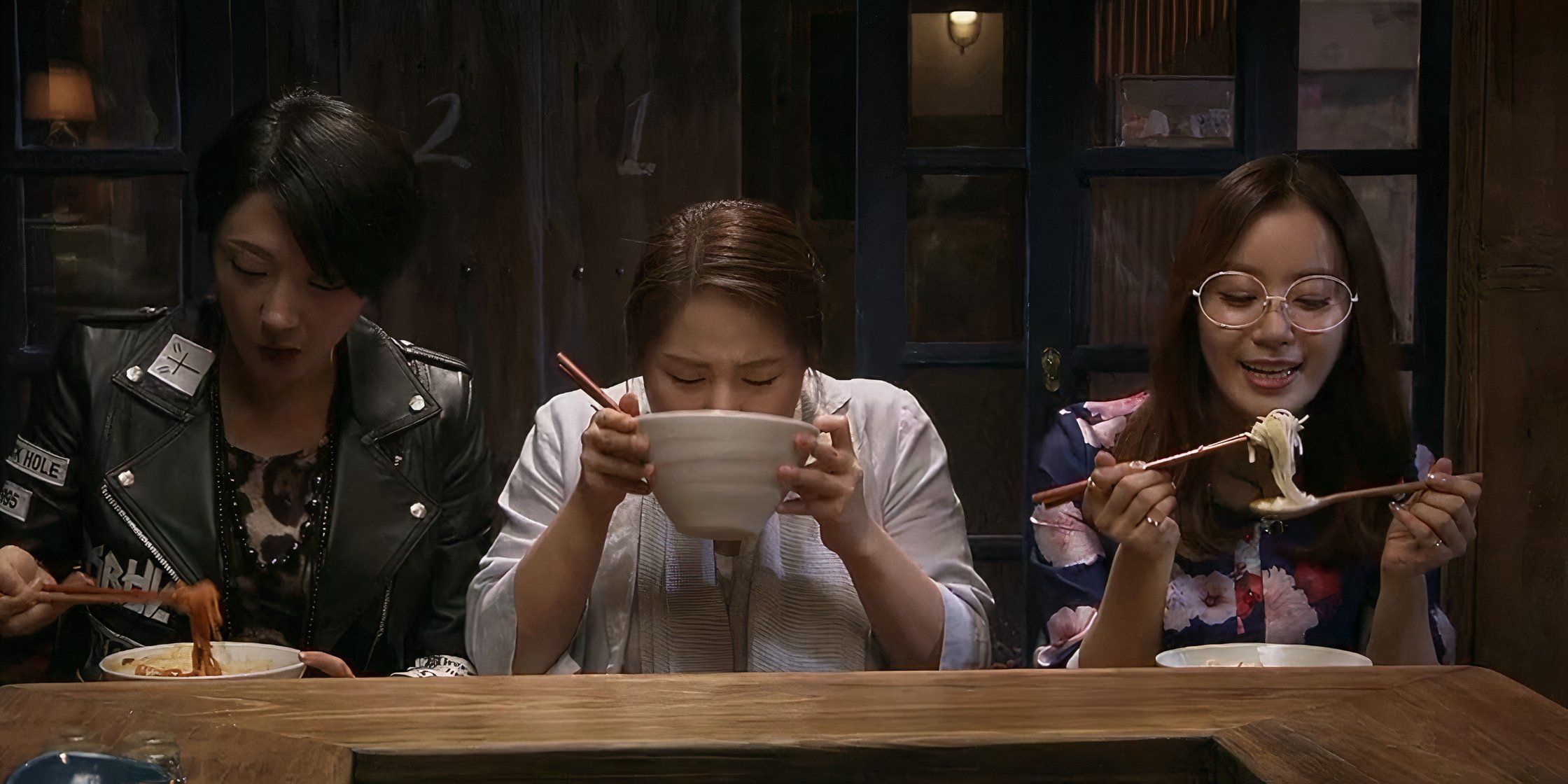 Three women eating different noodle dishes in the k-drama Late Night Restaurant