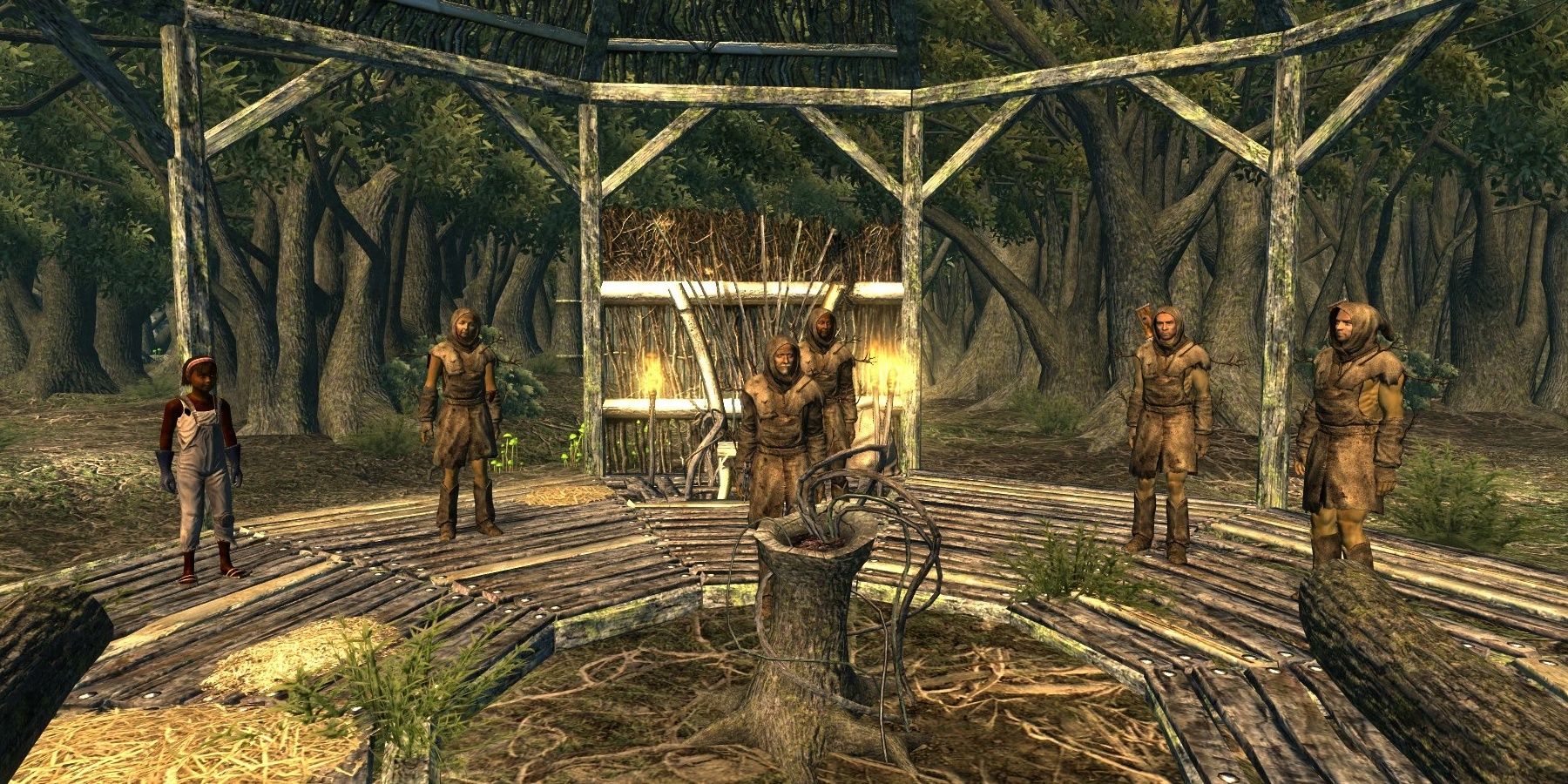 Treeminders de Fallout 3 em pé em um círculo ao redor de um toco de árvore. 