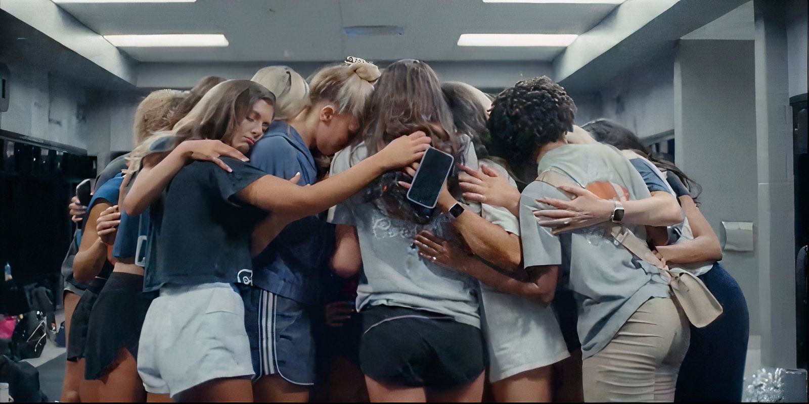 Dallas Cowboys Cheerleaders hugging in a locker room