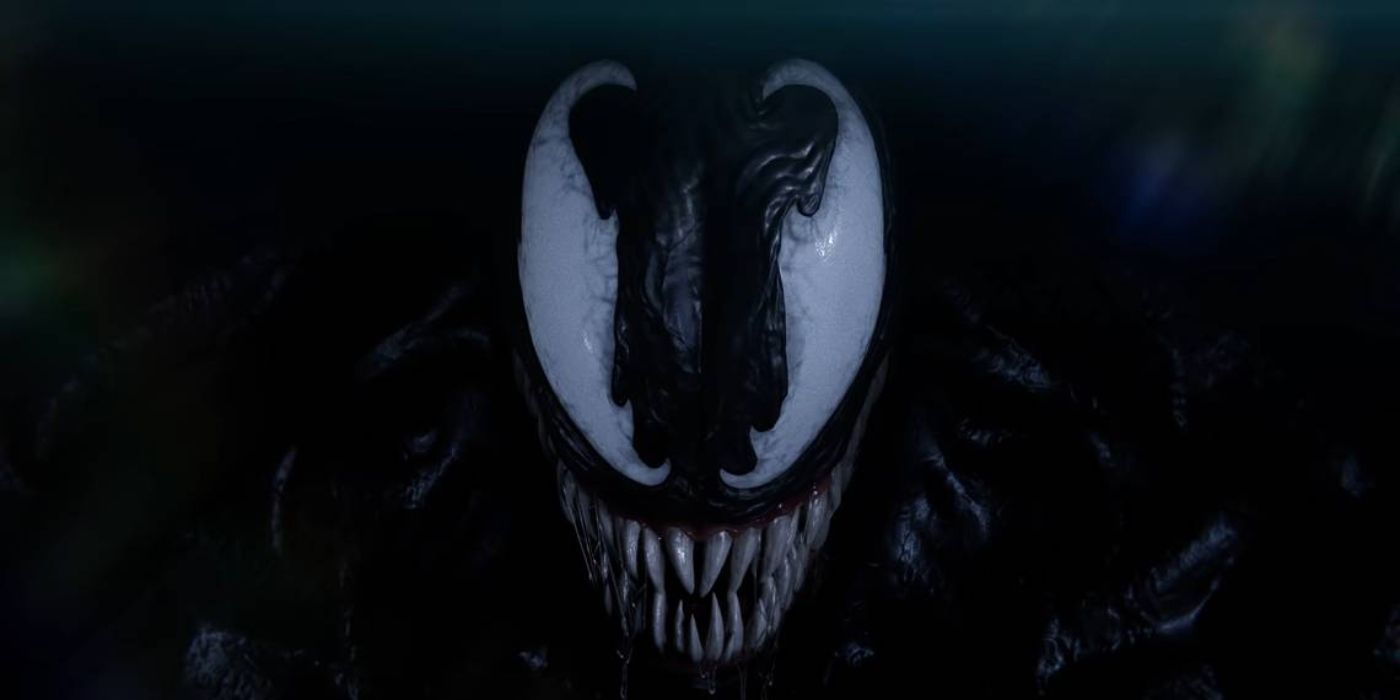 Venom from Marvel's Spider-Man 2 drenched in shadow, grinning at the viewer. 