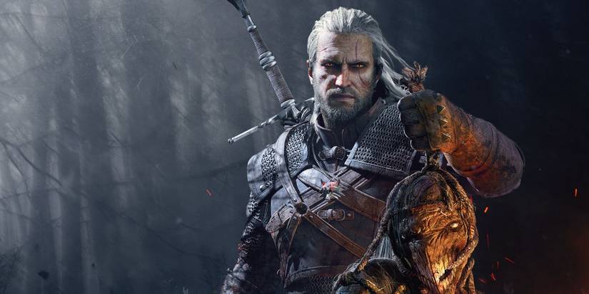 Geralt holding up the trophy of a monster's head