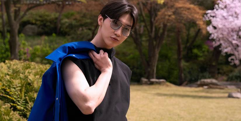 Min Ho looks on with his jacket slung over his shoulder in XO Kitty