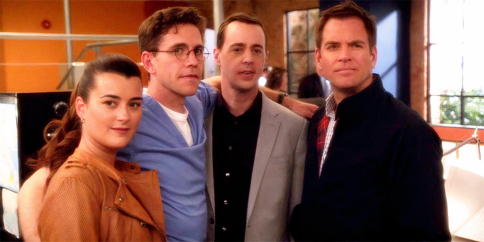 Ziva, Jimmy, McGee, & Tony huddling together in NCIS office