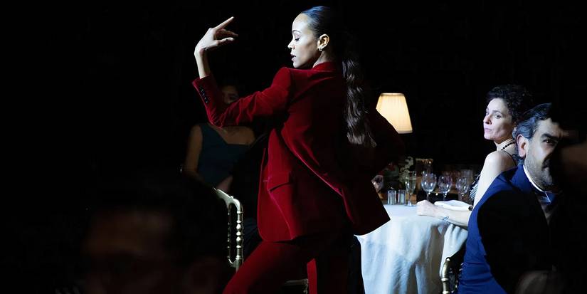 Zoe Saldana dancing with her red suit in Emilia Perez