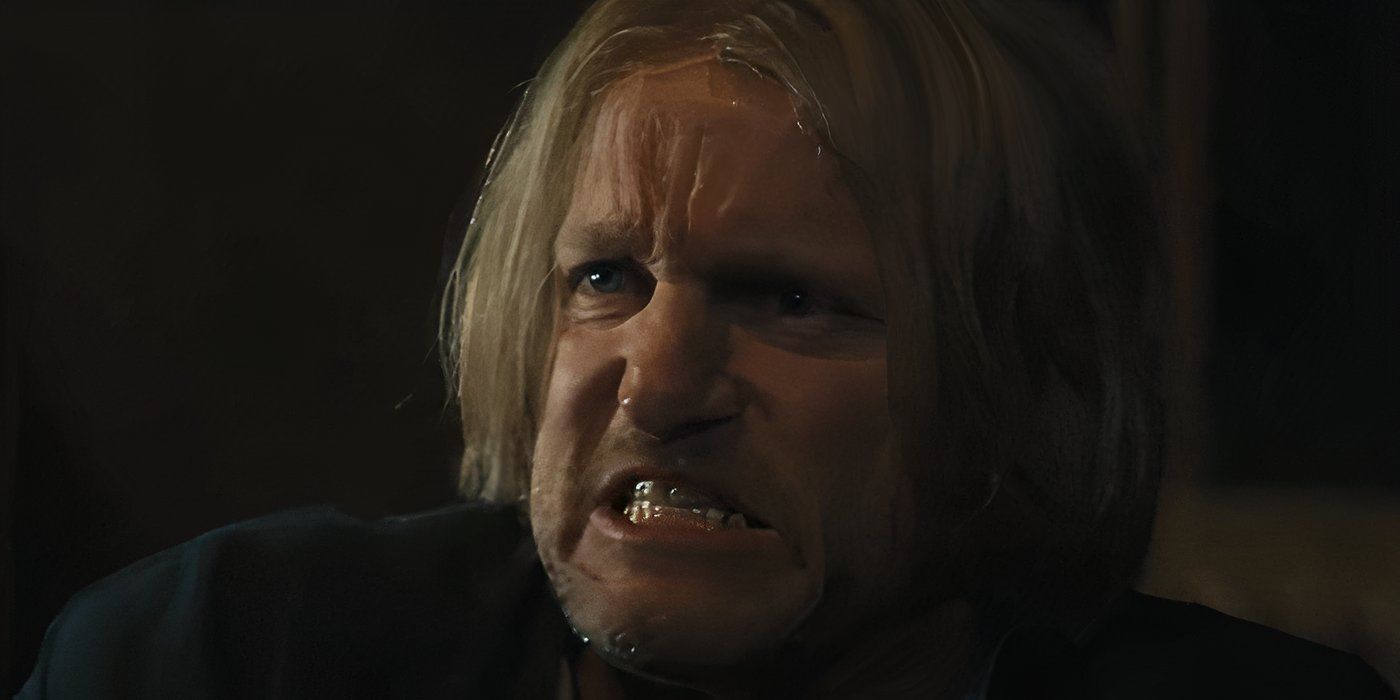 Haymitch, played by Woody Harrelson, is visibly angry and clenches his jaw at the news of the Quarter Quell.