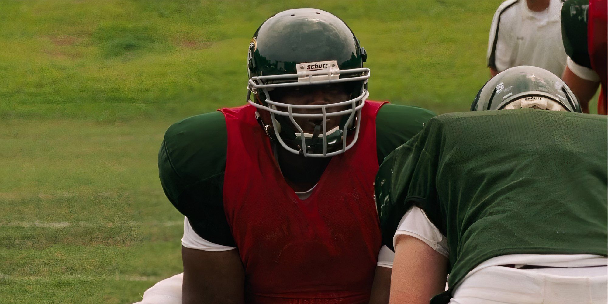 Quinton Aaron as Michael Oher playing football in The Blind Side