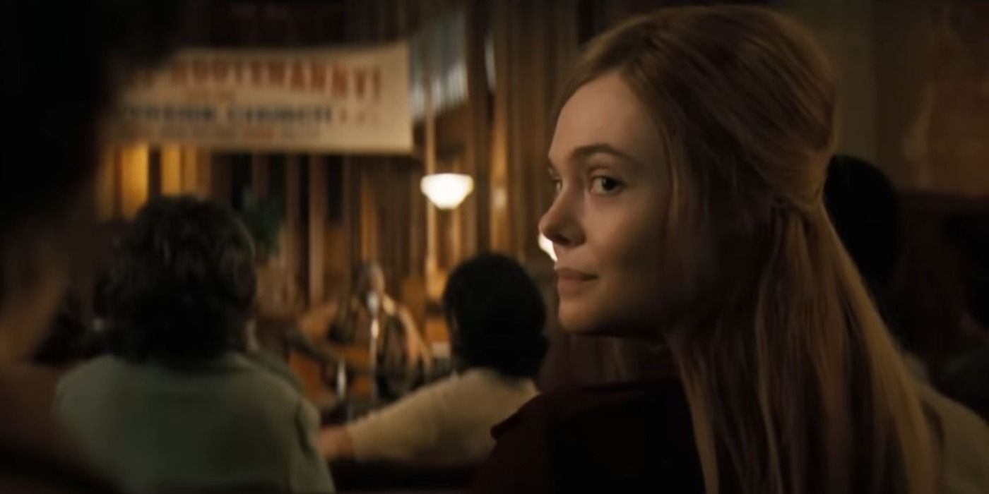 Elle Fanning as Sylvia Russo looking behind her seat in A Complete Unknown