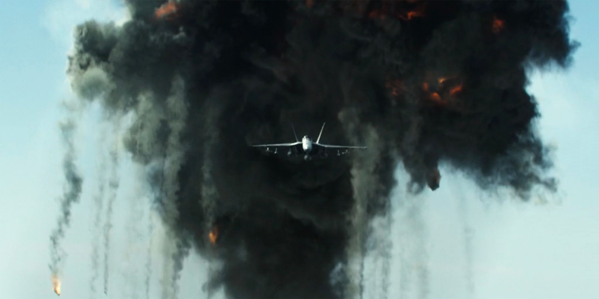 A fighter jet coming out of an explosion in Top Gun Maverick